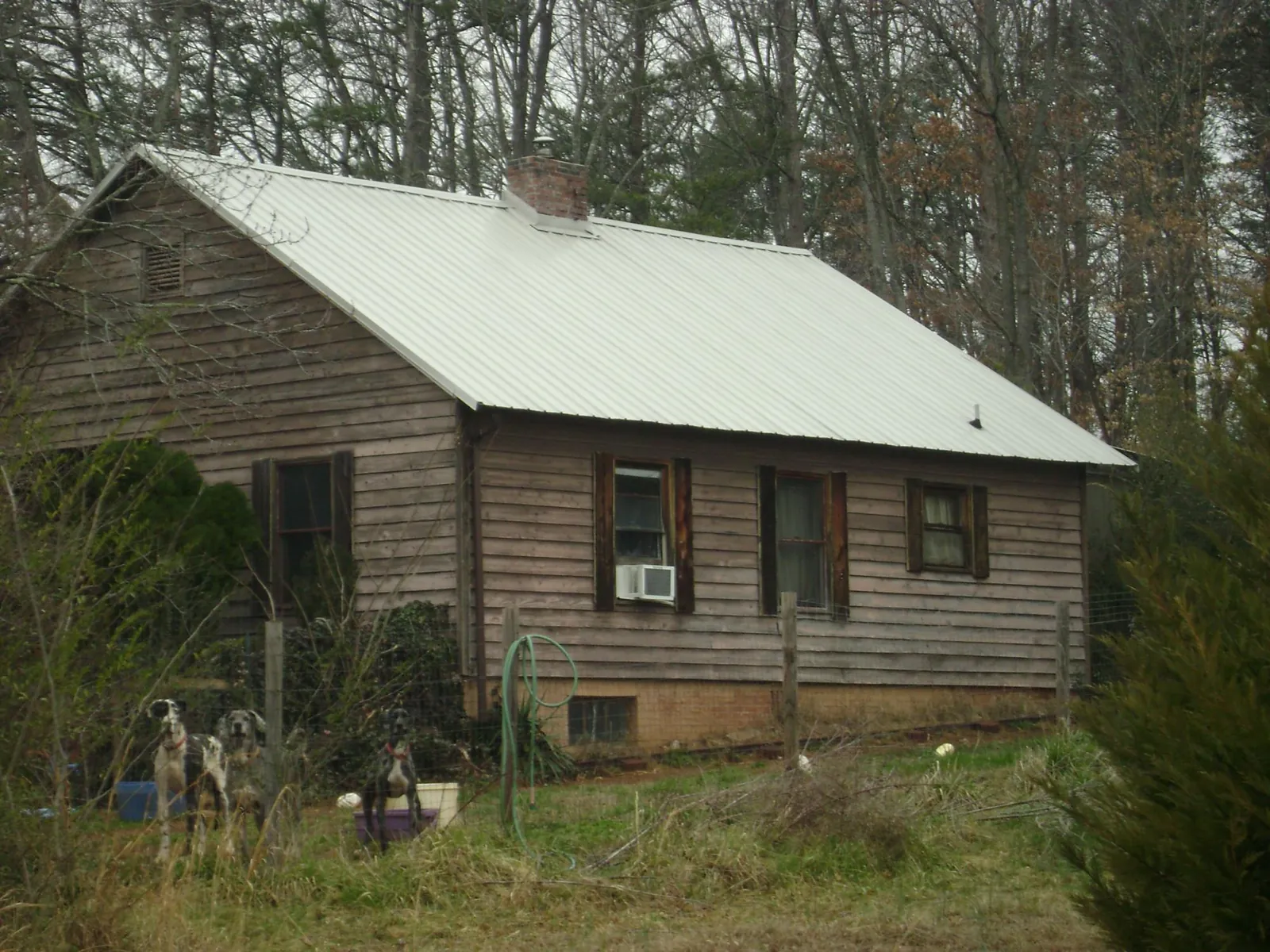 White metal roof on an old wood sided farmhouse, from a Metal Roof Installation job in Russell